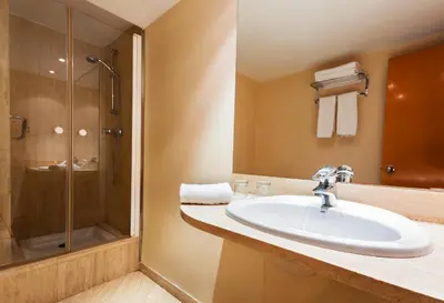 a bathroom with a sink and a shower at Hotel Villacarlos in Valencia