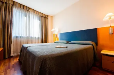 a hotel room with a bed and a window at Hotel Villacarlos in Valencia