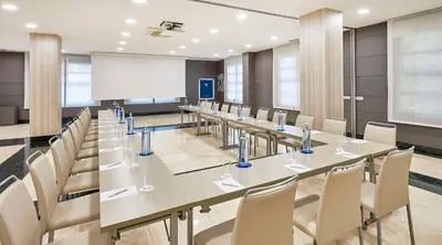 a conference room with a long table and chairs at NH Valencia Las Artes in Valencia