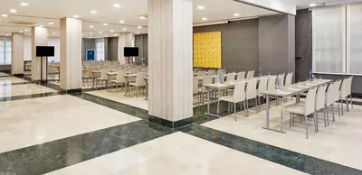 a conference room with tables and chairs in it at NH Valencia Las Artes in Valencia