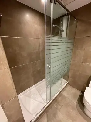 a shower stall in a bathroom with a toilet at PRIMERA LINEA PLAYA PATACONA, VALENCIA in Valencia