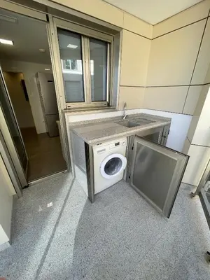a washing machine in a bathroom with a sink at PRIMERA LINEA PLAYA PATACONA, VALENCIA in Valencia