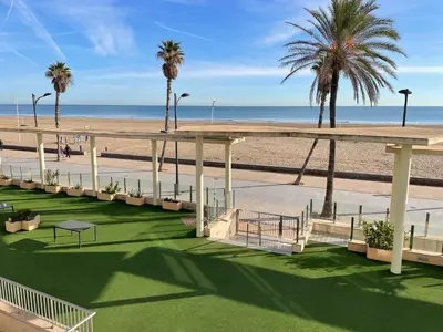 a view of the beach from the balcony of a resort at PRIMERA LINEA PLAYA PATACONA, VALENCIA in Valencia