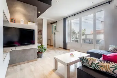 a living room with a couch and a tv at PENTHOUSE on the BEACH in Valencia