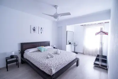 a bedroom with a bed and a ceiling fan at Marina Flat by Concept Flats in Valencia