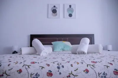 a bedroom with a large bed with a floral bedspread at Marina Flat by Concept Flats in Valencia