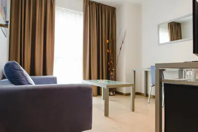 a room with a tv on a table and a bed at Hotel Mas Camarena in Paterna