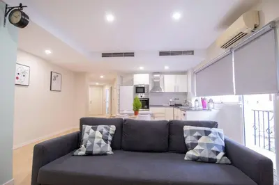 a living room with a couch and a kitchen at Old Town Flat by Concept Flats in Valencia
