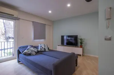 a bedroom with a bed and a flat screen tv at Old Town Flat by Concept Flats in Valencia