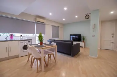 a kitchen and living room with a table and a couch at Old Town Flat by Concept Flats in Valencia