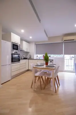 a kitchen with a table and chairs in a room at Old Town Flat by Concept Flats in Valencia