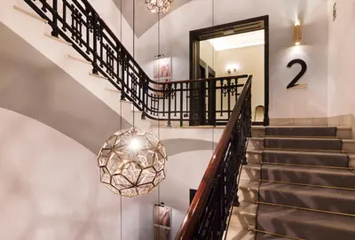a staircase with a chandelier in a house at One Shot Reina Victoria in Valencia