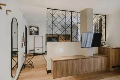 a living room with a flat screen tv on a cabinet at Hotel Dimar in Valencia
