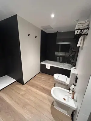 a bathroom with a white toilet and a sink at Hotel Dimar in Valencia
