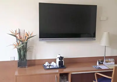 a flat screen tv hanging on a wall at Hotel RH Sorolla Centro in Valencia