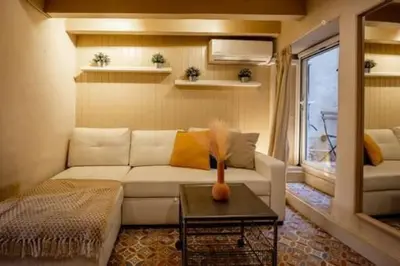 a living room with a white couch and a table at Lovely Coquette loft, heart of cuitat vella El Carmen Valencia in Valencia