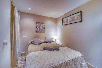 a bedroom with a large bed with purple pillows at Lovely Coquette loft, heart of cuitat vella El Carmen Valencia in Valencia