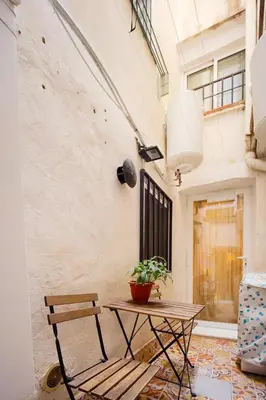 a table and a bench in front of a building at Lovely Coquette loft, heart of cuitat vella El Carmen Valencia in Valencia
