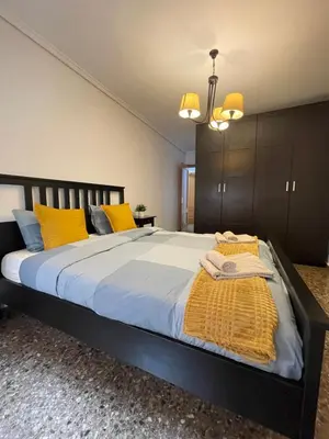 a bedroom with a large bed with yellow pillows at UIM Mediterraneo Claveles Wifi in Puerto de Sagunto