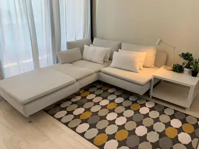 a living room with a white couch and a rug at Manises POLIGONO in Manises