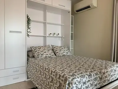 a bedroom with a bed and a white cabinet at Manises POLIGONO in Manises