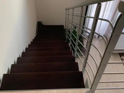 a staircase in a house with a metal railing at Manises POLIGONO in Manises