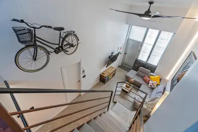 a bike hanging on a wall in a living room at Loft Nou Benicalap - Housevanlive in Valencia