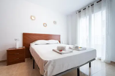 a bedroom with a bed with two dishes on it at Excelente apartamento en 2ª línea de playa by Hometels in Puerto de Sagunto