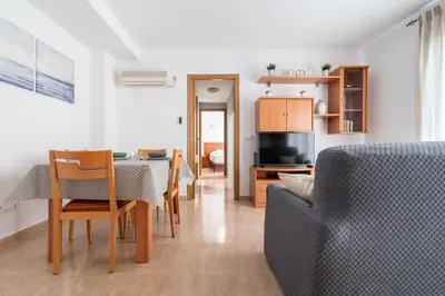 a living room with a table and a couch at Excelente apartamento en 2ª línea de playa by Hometels in Puerto de Sagunto