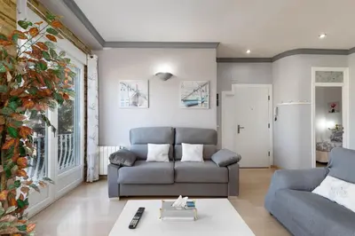 a living room with a couch and a table at Malvarrosa Las Arenas I in Valencia