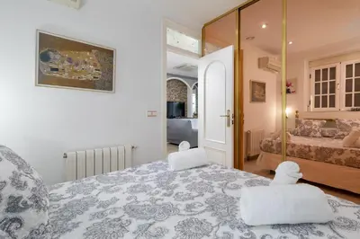 a bedroom with a bed with two white towels on it at Malvarrosa Las Arenas I in Valencia