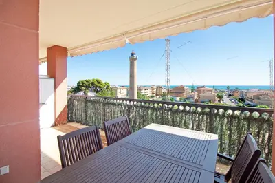 a table and chairs on a balcony with a view at Global Vacacional, Apartamento con gran terraza y piscina in Canet de Berenguer