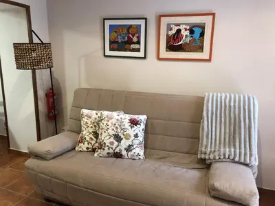 a couch with two pillows on it in a living room at Casa Puri in Jérica