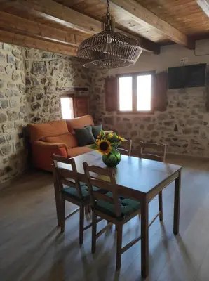 a living room with a table with chairs and a couch at Casa el Recreo in Jérica