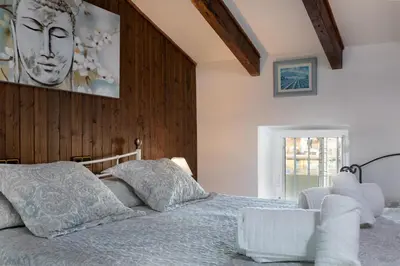 a bedroom with a bed with a wooden wall at Malvarrosa Las Arenas II in Valencia