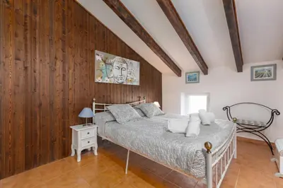 a bedroom with a bed and a wooden wall at Malvarrosa Las Arenas II in Valencia