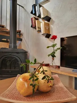 two melons on a table with a vase with a rose at Casa rural El Forn d'Alcudia de Veo in Alcudia de Veo