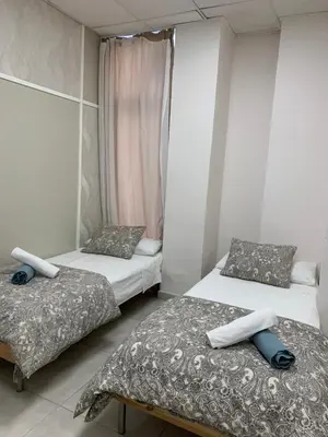 two beds in a small room with two bedsskirts at Alex- DUPLEX APARTMENT- City in Valencia