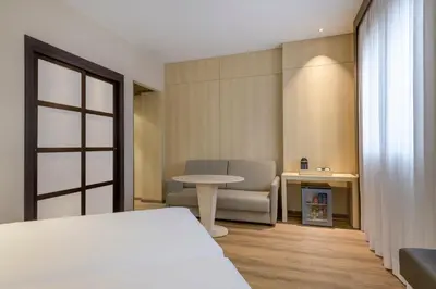 a room with a bed and a table and a chair at AC Hotel Valencia by Marriott in Valencia