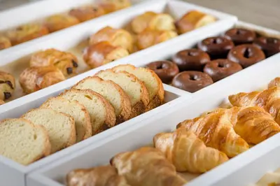 a display of different types of pastries and donuts at AC Hotel Valencia by Marriott in Valencia