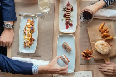a table with plates of food on top of it at AC Hotel Valencia by Marriott in Valencia