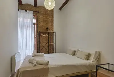 a large bed in a white room with a window at Enjoy Apartment 4 pax at Ruzafa with sunny terrace in Valencia