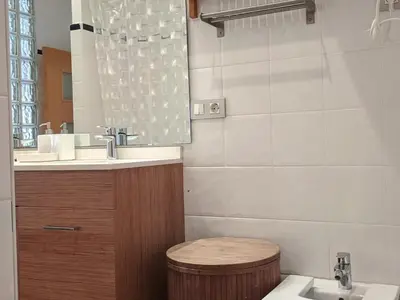 a bathroom with a sink and a toilet and a mirror at Enjoy Apartment 4 pax at Ruzafa with sunny terrace in Valencia
