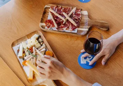 a table with a plate of food and a glass of wine at Hotel Kramer in Valencia