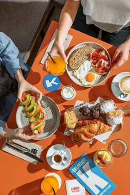 a table with plates of breakfast food on it at Hotel Kramer in Valencia