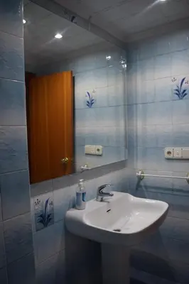 a bathroom with a sink and a mirror at Apartamento Florazar 2, 10ºC Cullera in Faro de Cullera