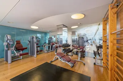 a gym with treadmills and elliptical machines at Las Arenas Balneario Resort in Valencia