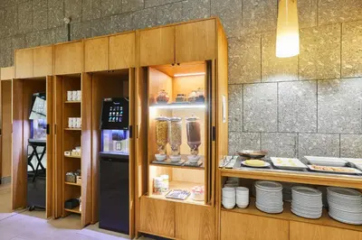 a display case in a restaurant with plates in it at Silken Puerta Valencia in Valencia