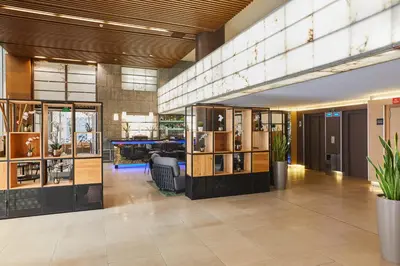 a lobby of a building with a store at Silken Puerta Valencia in Valencia