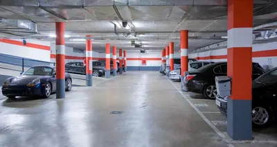 a large parking garage with cars parked in it at Silken Puerta Valencia in Valencia
